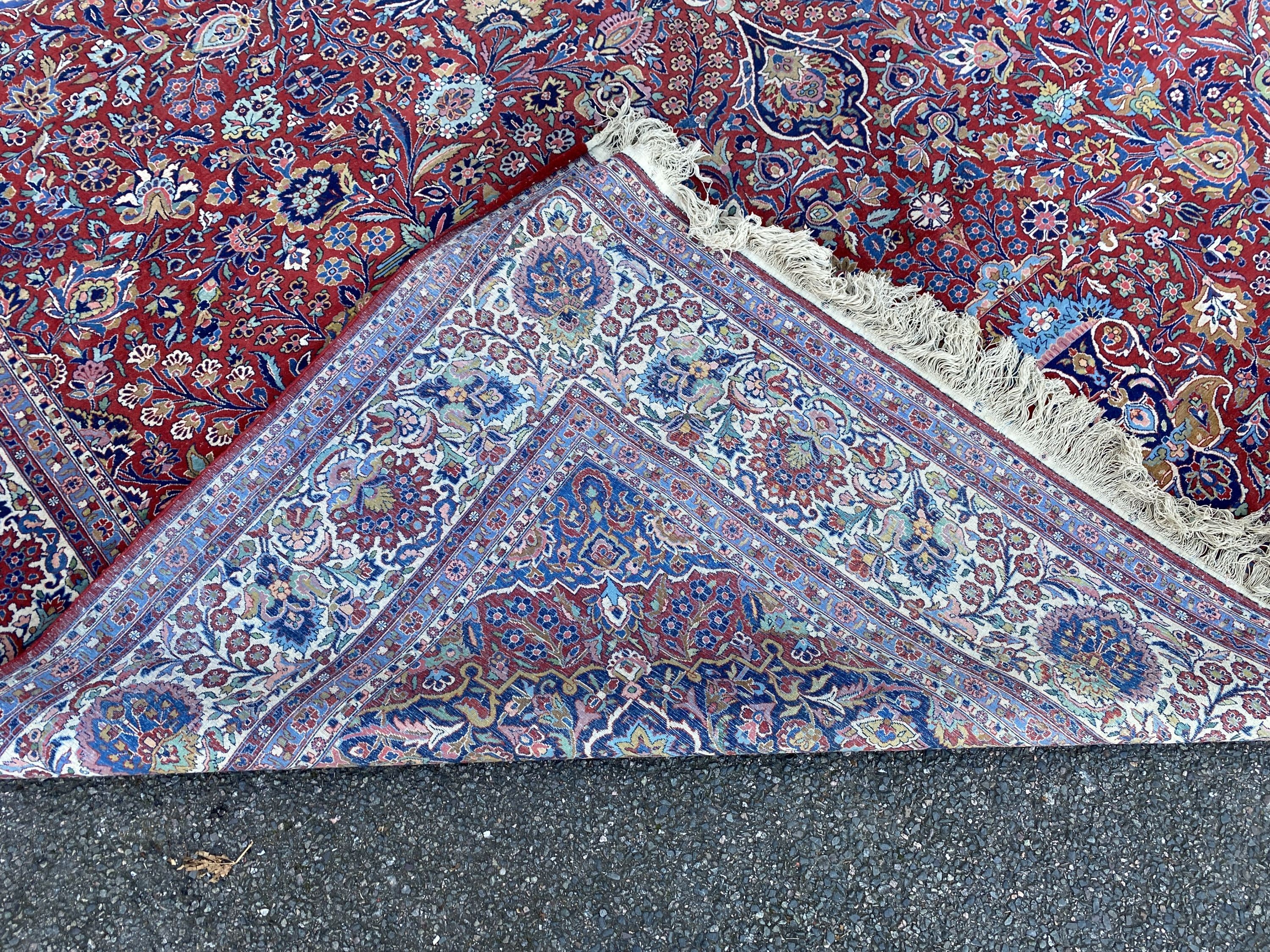 A Tabriz red ground carpet with, first half 20th century, 510cm x 355cm